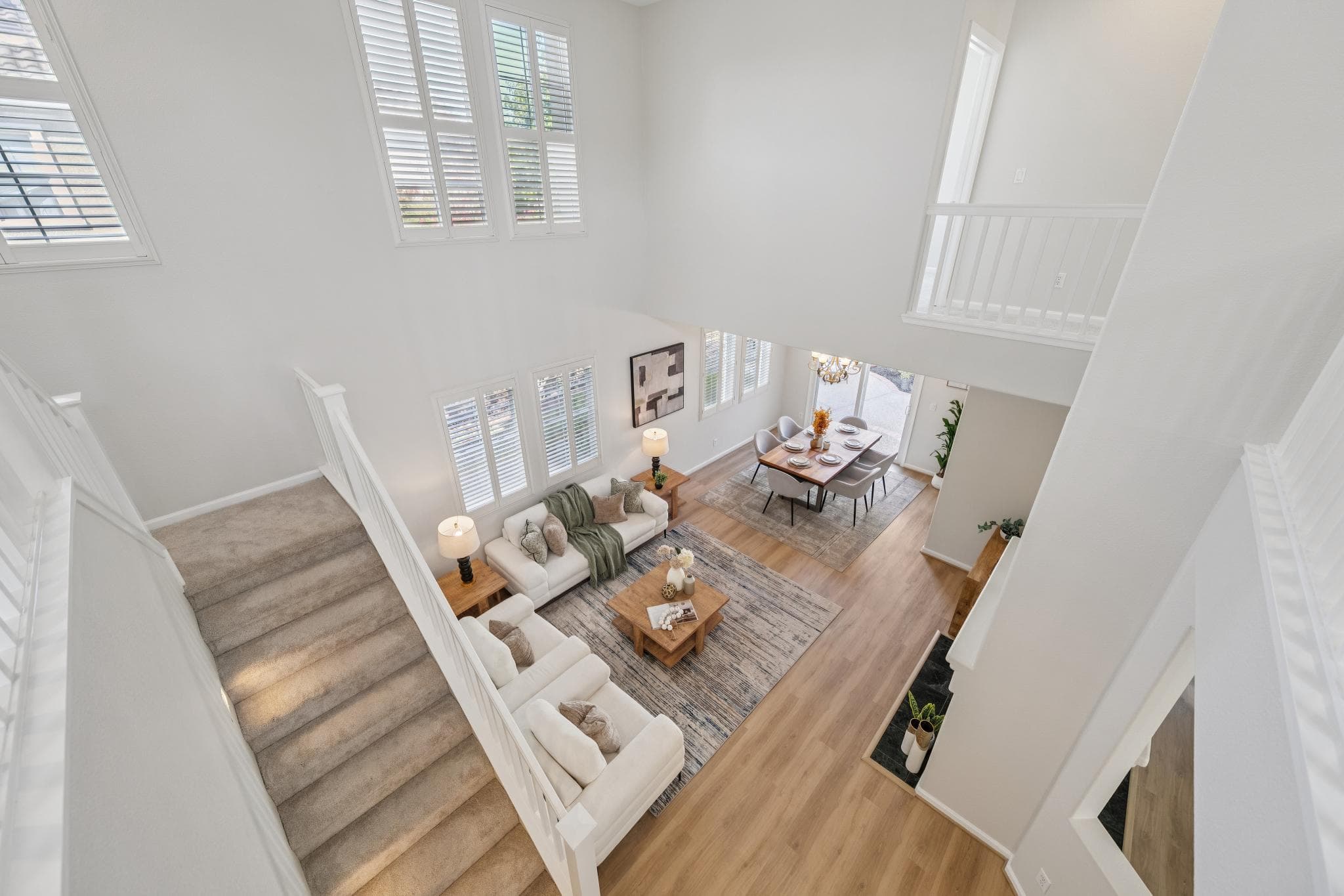 View from the upper landing down into the double-height living room and dining area